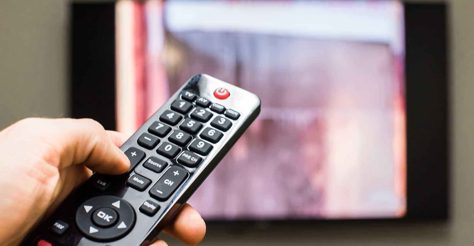 hand clicking TV remote
